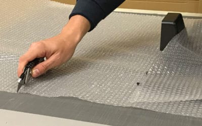 Worker Cutting Bubble Wrap